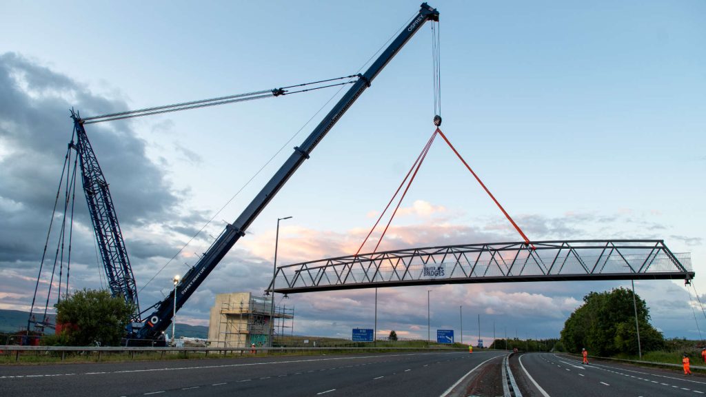 Working platform carrying bridge over road