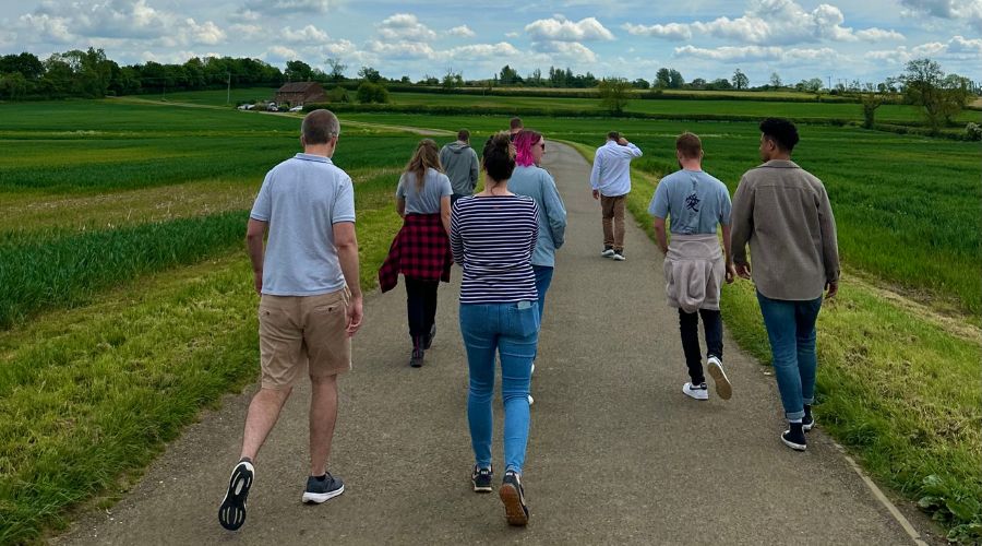 Individuals from Soiltechnics walking amongst fields.