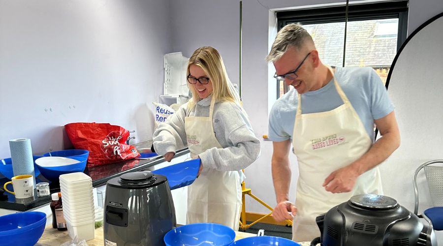 Woman and man making their own pizza.